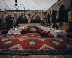 a banquet hall with a red carpet and tables